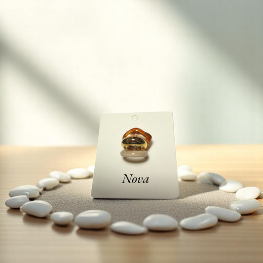 Anillos dorado, crema y caramelo en disposición vertical sobre soporte
