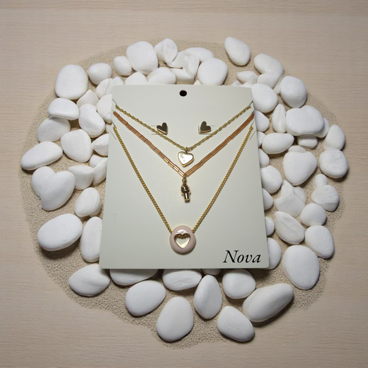 Set de collares layering dorados con dijes de corazón y aretes en fondo natural